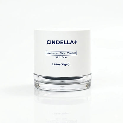 CINDELLA+ Premium Skin Cream in a clear glass jar with a white label, set against a clean white background with a soft reflection.