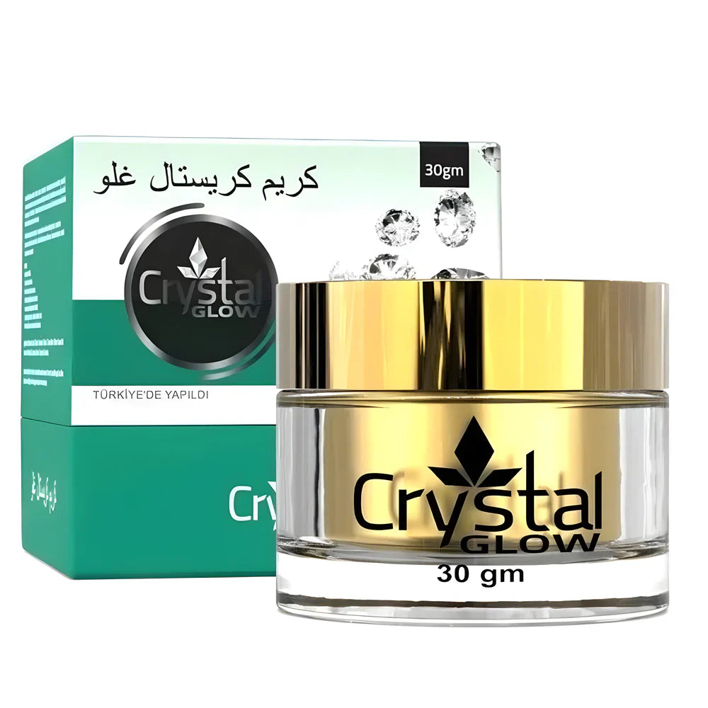 Gold jar and green box of Crystal Glow cream on a white background