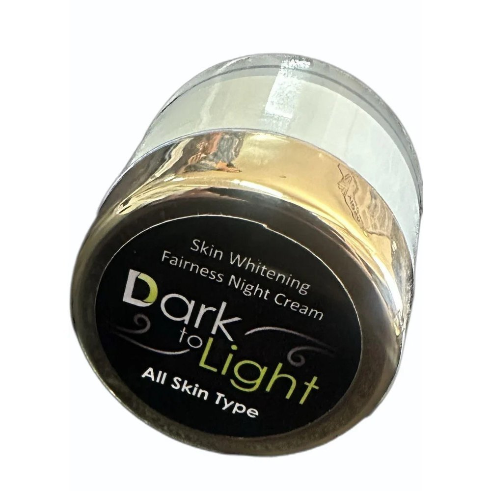 Jar of 'Dark to Light' skin whitening fairness night cream on a white background